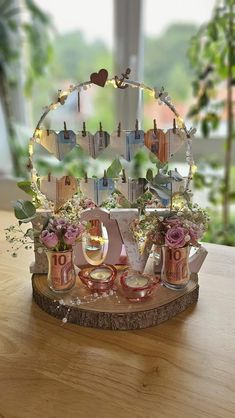 a wooden table topped with lots of pink and white flowers next to a mirror on top of it