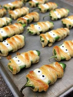 some food is on a pan and ready to be cooked in the oven with eyes drawn on them