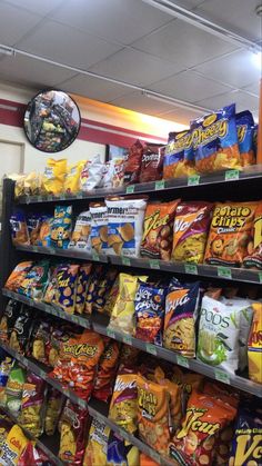 a store filled with lots of different types of snacks on display in front of the camera