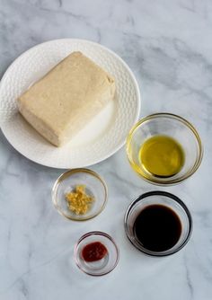 the ingredients to make this dessert are displayed on a marble counter top, including olives and oil