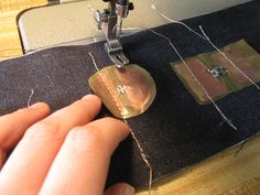 someone is using a sewing machine to sew on some material that has been stitched together