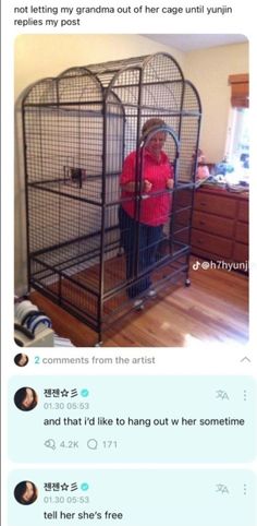 an old woman is standing in a cage with her hands on the back of it