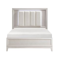 a white bed with an upholstered headboard and foot board on the side