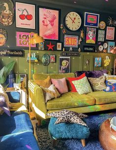 a living room filled with lots of colorful furniture and pictures on the wall above it