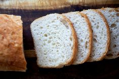 slices of white bread sitting on top of a cutting board