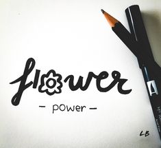 a black pen sitting on top of a piece of paper with the word lisquer written in cursive writing