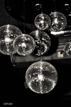 disco balls hanging from the ceiling in black and white