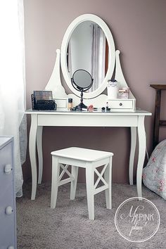 a white dressing table with stool and mirror