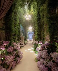 a garden filled with lots of flowers next to a lush green canopy over a walkway