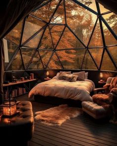 a bedroom with a glass dome ceiling and bed in the middle, surrounded by trees