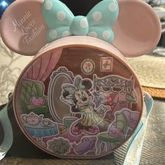 a minnie mouse purse with a bow on it's head and the name minnie mouse