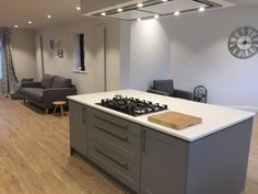 a kitchen with an island, stove and couches