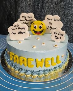 a birthday cake decorated with an emoticive smiley face and some writing on it