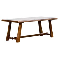 a wooden table with two legs and a white surface on the top, against a white background