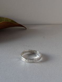 a silver ring sitting on top of a table