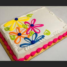 a decorated birthday cake with flowers on it