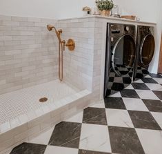 a washer and dryer in a bathroom with black and white checkered floor