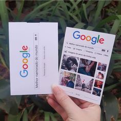 someone is holding up two business cards in front of some plants and grass with the google logo on them