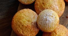 some sugary muffins are on a wooden board