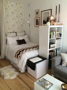 a bedroom with a bed, chair and bookshelf