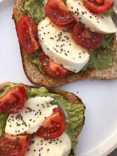 two pieces of bread with avocado and tomatoes on them