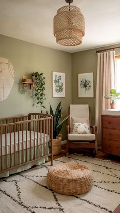 An earthy green nursery with natural wood furniture, cozy decor, and botanical artwork for a warm, nature-inspired feel. Nursery Light Green Walls, Green Crib Nursery Girl, Nursery Ideas Earth Tones, Gender Neutral National Park Nursery, Evergreen Fog Nursery Boy, Cozy Girl Nursery, Earthy Tone Nursery, Nursery With Brown Furniture