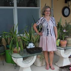 a woman standing in front of some plants