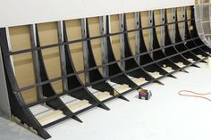 there are many shelves that have been built into the wall with metal bars attached to them