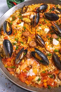 a paella with shrimp, mussels and sausage