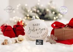 a baby's first christmas ornament next to presents