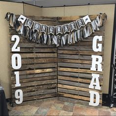 a sign made out of wooden pallets that reads congratulations 2013 and the word grad spelled in white letters