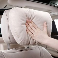 a person holding their hand on the back seat of a car while it's inside