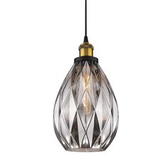 a glass and brass pendant light hanging from a black cord with an intricate design on it