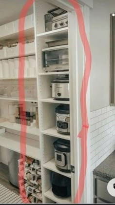 a kitchen with white cabinets and red lines on the wall next to the counter top