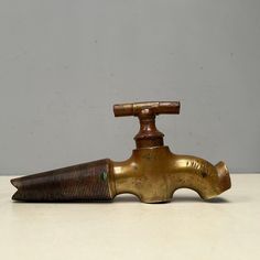 an old fashioned brass faucet sitting on a table