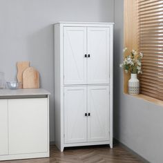 a white cabinet sitting next to a window