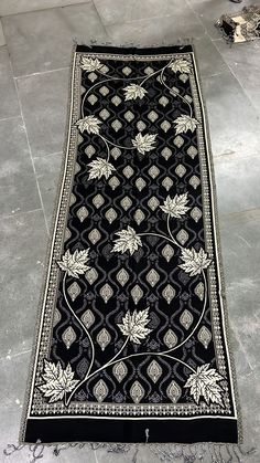 a black and white rug is laying on the floor