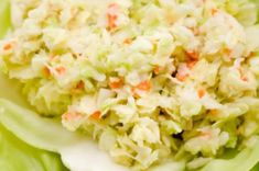 this is a close up view of coleslaw salad on a plate with carrots and celery