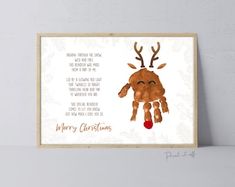 a christmas card with a reindeer's hand holding a red ornament, and the words merry christmas on it