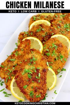 chicken cutlets with lemons and parsley on a white platter for garnish