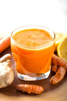 carrots and ginger juice on a wooden table