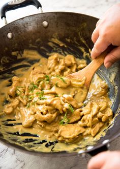 a person is stirring some food in a pan