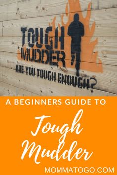 a wooden sign with the words tough mudder written on it and an orange background