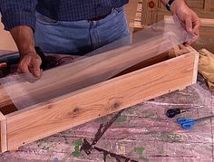 a man is working on some wood in his workshop with scissors and plywoods