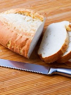 a loaf of bread sitting on top of a cutting board next to a knife