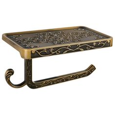 an ornately decorated metal shelf with gold trimmings on the top and bottom