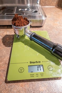 a scale that has some food on top of it and a blender in the background