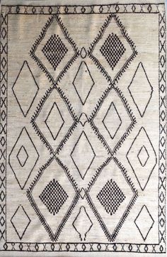 an old rug with black and white designs on it