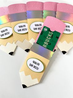 four pieces of paper with labels on them sitting next to each other in the shape of a rainbow