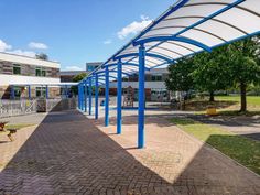 an outdoor area with benches and blue poles